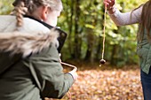 Two girls playing conkers