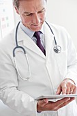 Male doctor using tablet