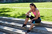 Young woman resting with water bottle