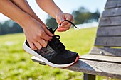 Woman tying up trainers