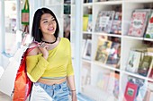 Woman walking past book shop window