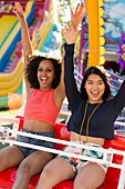 Women on fairground ride at fun fair