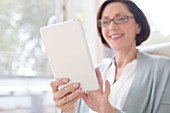 Mature woman using digital tablet