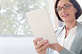 Mature woman using digital tablet