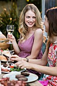 Woman having lunch outdoors with friends