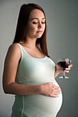 Pregnant teenager drinking wine