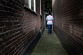 Nurse walking along an alley