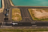 Planes on runway, Honolulu, Hawaii, USA, aerial photograph