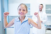 Portrait of girl cheering in doctor's surgery