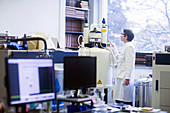 Chemist using NMR spectrometer