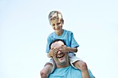 Father carrying son on shoulders