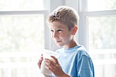 Boy drinking milk through a straw