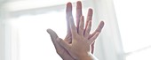 Child and adult touching hands