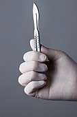 Person holding scalpel