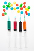 Four syringes with colourful liquid spots