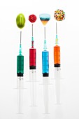 Four syringes with colourful sweets