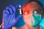 Healthcare worker with vaccine bottle