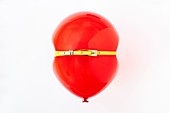 Red balloon, conceptual image of bloated stomach