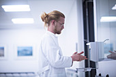 Male doctor using hand sanitiser