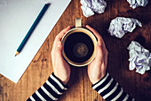 Female writer drinking cup of coffee