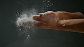 Person with flour on hands, slow motion