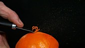 Zesting an orange, slow motion