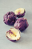 Baby purple artichokes, whole and halved