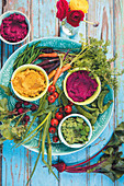 Carrot and ginger dip, beetroot and cauliflower dip, and pea and broccoli dip with mint