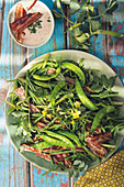 A green vegetable salad with smoked bacon
