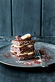A stack of chocolate cracker with bananas and cocoa mousse