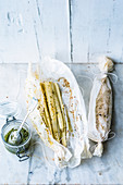 Black salsify in parchment paper with parsley pesto