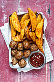 Meatballs with potato wedges and BBQ sauce