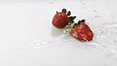 Strawberries in water, slow motion
