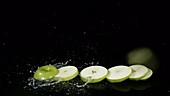 Apple slices falling, slow motion