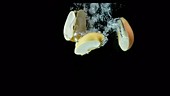 Apple falling in water, slow motion