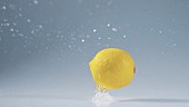 Lemon falling in water, slow motion
