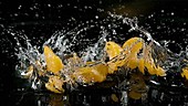 Orange falling in water, slow motion