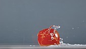Cherry tomato moving in water, slow motion