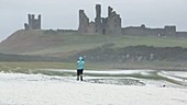 Woman in a storm on the coast