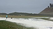 Woman in a storm on the coast