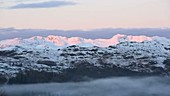 Dawn light on snowy peaks