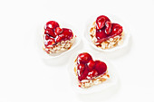 Three heart-shaped strawberry and almond tarts