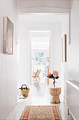 Light-flooded hallway with white floor and white walls