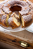 Marble cake with icing sugar, partly sliced