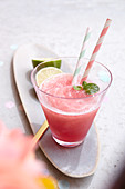 A glass of Frosé with two straws