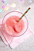 A glass of Frosé with a straw