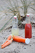 Sauerkraut juice and carrot juice in bottles