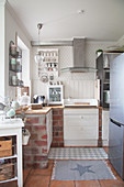 Brick base units in corner of Nordic-style kitchen
