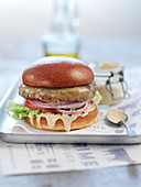A burger with truffle sauce and red onions