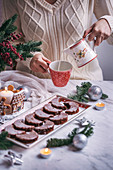 Woman eating Christmas chocolate crescent cookies and drinking milk